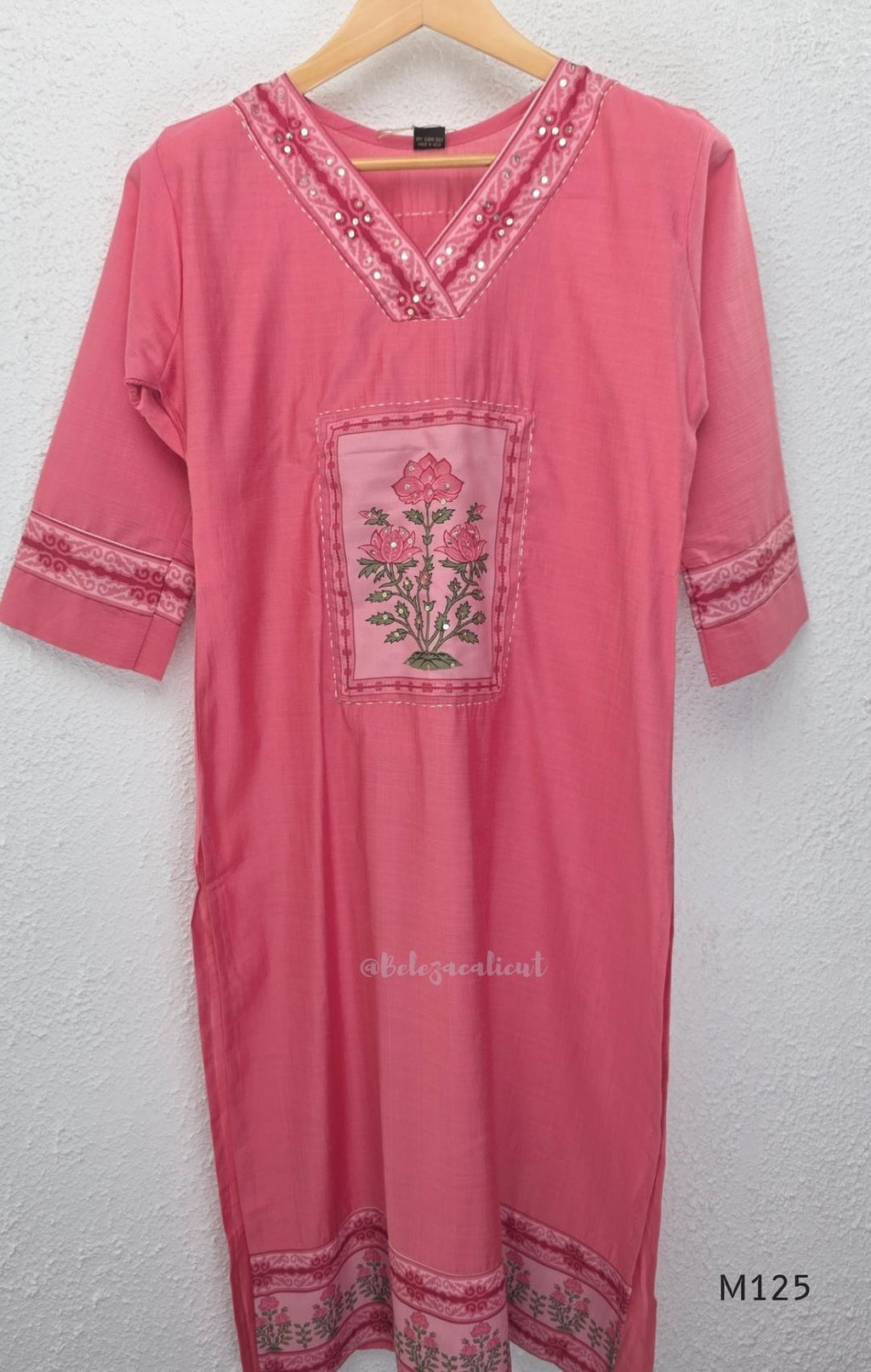 Rose pink silk blend 3-piece churidar set with floral patch panels, decorated V-neck, loose plain bottom and printed floral dupatta.