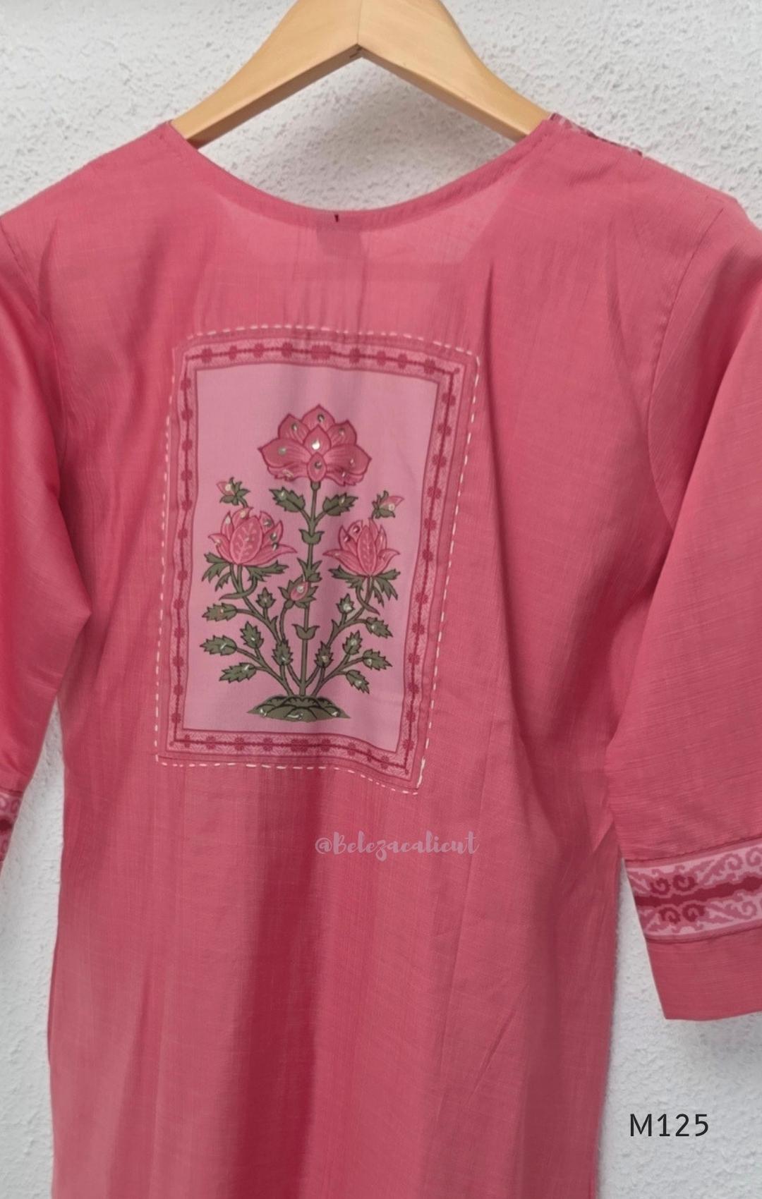 Rose pink silk blend 3-piece churidar set with floral patch panels, decorated V-neck, loose plain bottom and printed floral dupatta.