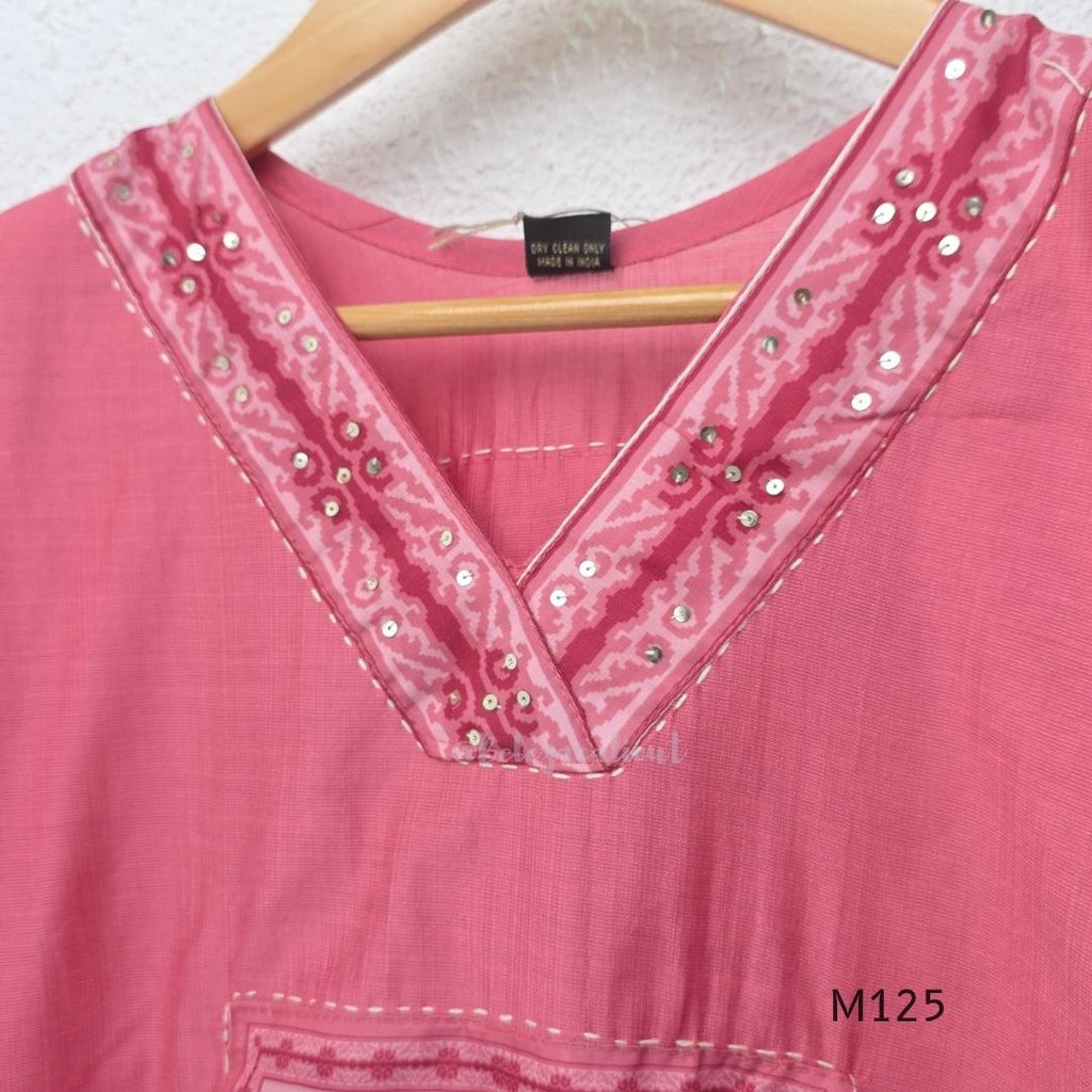 Rose pink silk blend 3-piece churidar set with floral patch panels, decorated V-neck, loose plain bottom and printed floral dupatta.