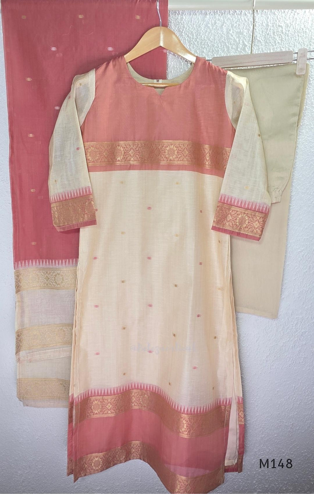 Rose pink and ivory tissue blend churidar set with woven gold borders, scattered motifs, straight bottom and matching dupatta.