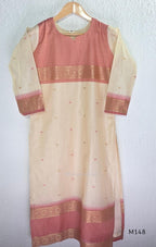 Rose pink and ivory tissue blend churidar set with woven gold borders, scattered motifs, straight bottom and matching dupatta.