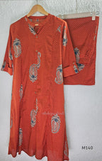 Rust-orange cotton co-ord set with dotted paisley print, A-line top and straight wide-leg bottom.