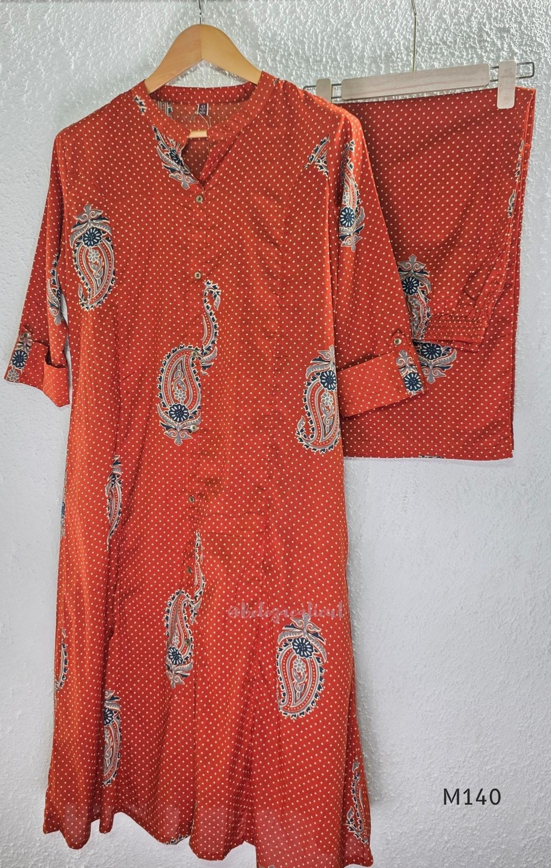 Rust-orange cotton co-ord set with dotted paisley print, A-line top and straight wide-leg bottom.