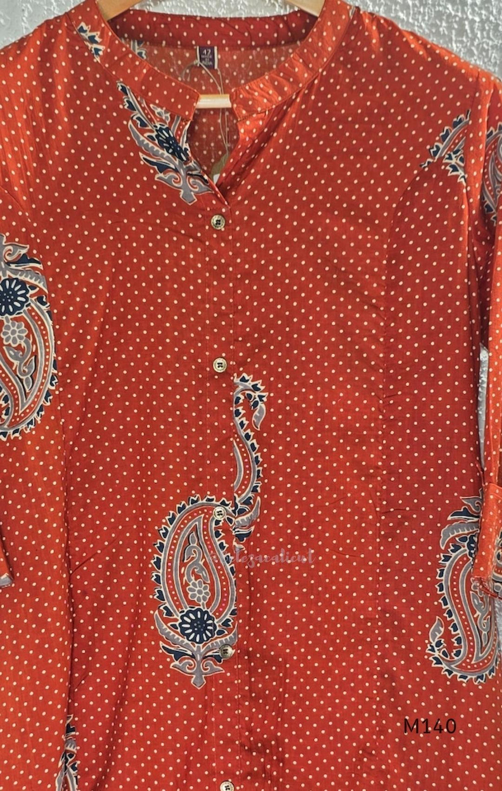 Rust-orange cotton co-ord set with dotted paisley print, A-line top and straight wide-leg bottom.