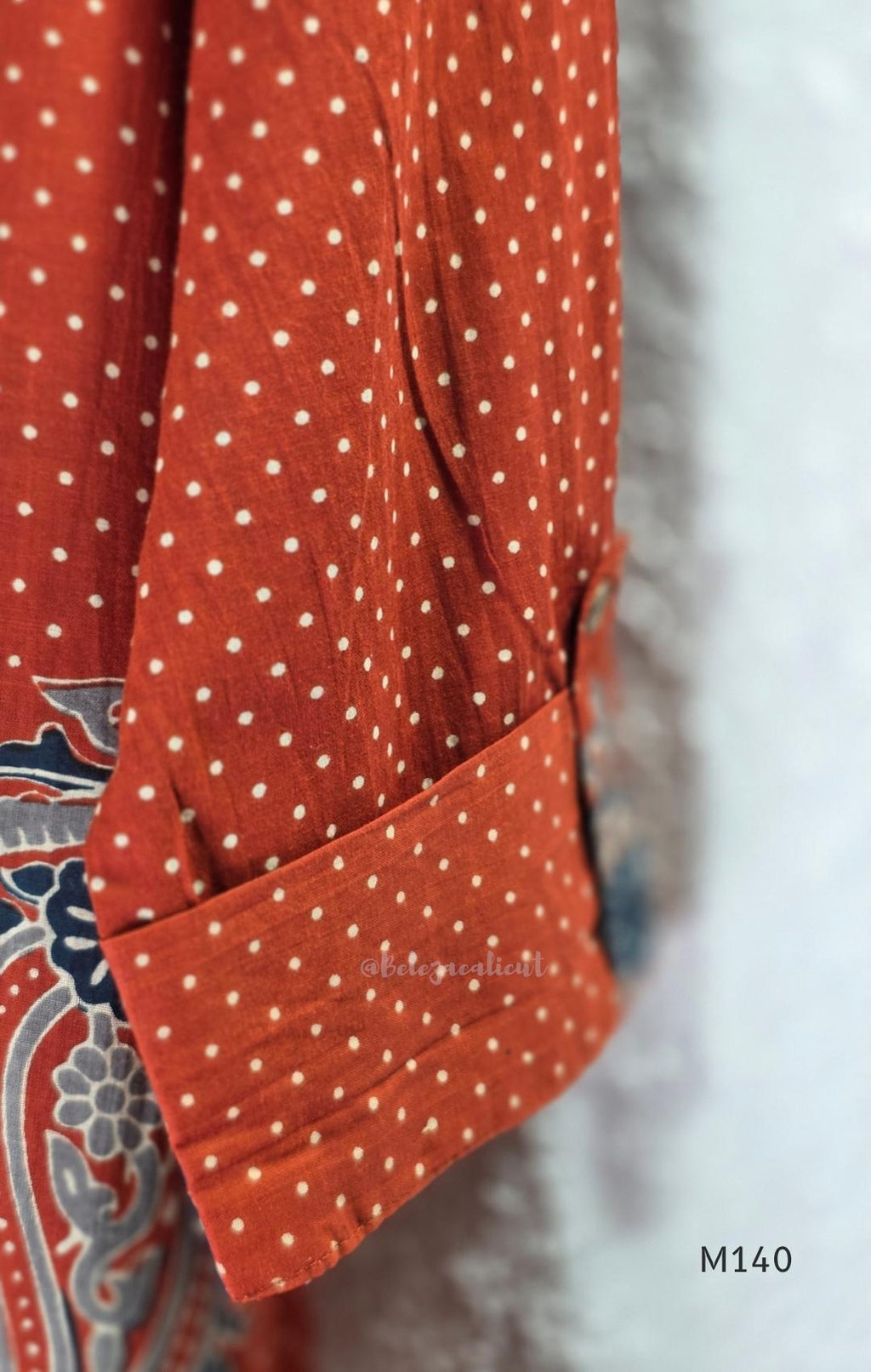 Rust-orange cotton co-ord set with dotted paisley print, A-line top and straight wide-leg bottom.