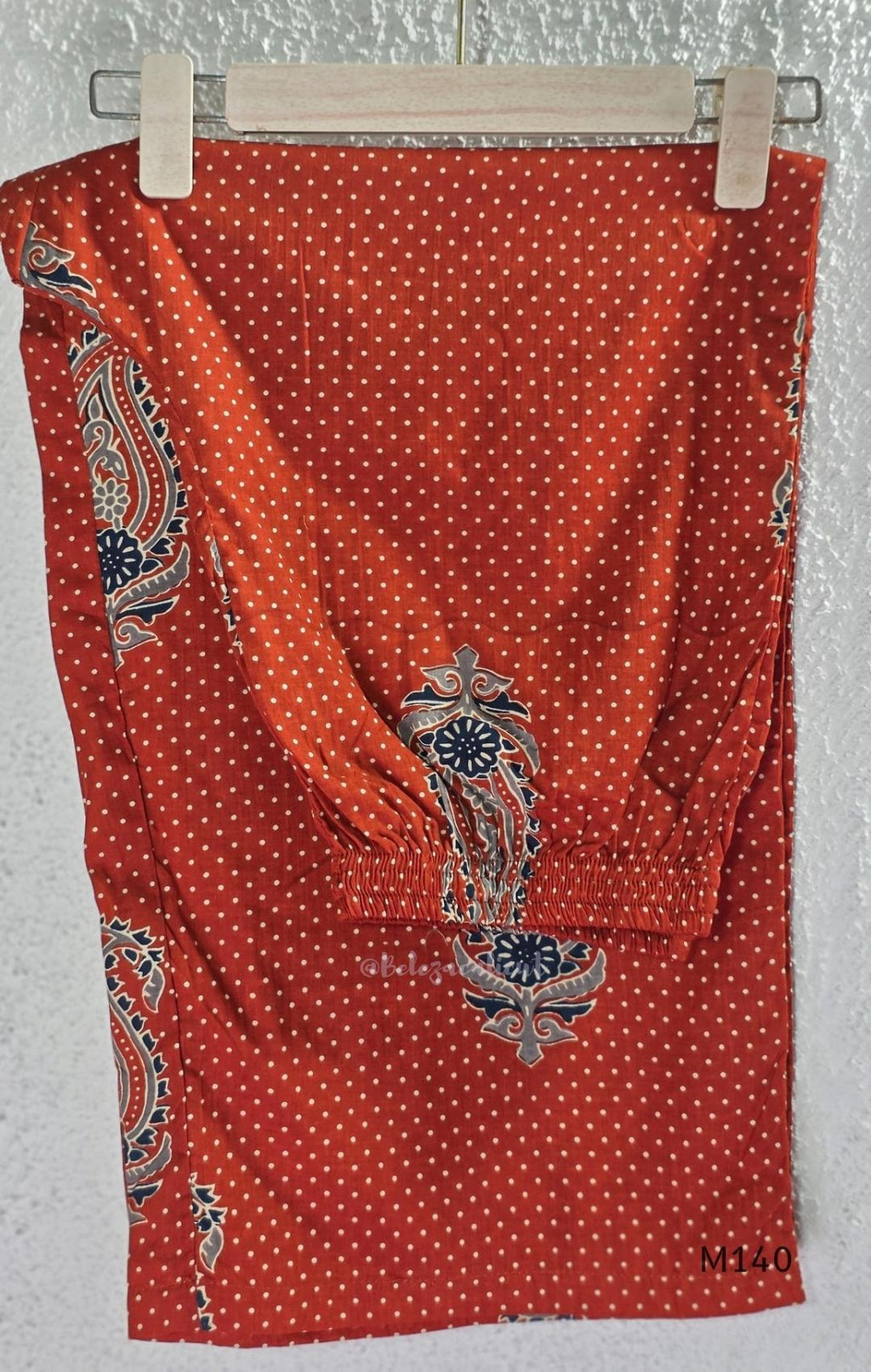 Rust-orange cotton co-ord set with dotted paisley print, A-line top and straight wide-leg bottom.
