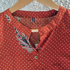 Rust-orange cotton co-ord set with dotted paisley print, A-line top and straight wide-leg bottom.