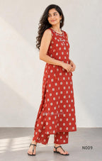 Rust red cotton 2-piece co-ord set with cream and navy motifs, mirror neckline detail and relaxed wide-fit pants.
