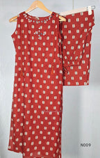 Rust red cotton 2-piece co-ord set with cream and navy motifs, mirror neckline detail and relaxed wide-fit pants.