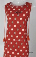 Rust red cotton 2-piece co-ord set with cream and navy motifs, mirror neckline detail and relaxed wide-fit pants.