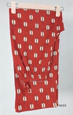 Rust red cotton 2-piece co-ord set with cream and navy motifs, mirror neckline detail and relaxed wide-fit pants.