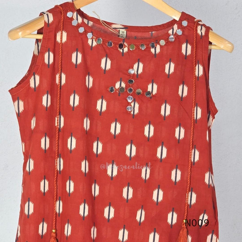 Rust red cotton 2-piece co-ord set with cream and navy motifs, mirror neckline detail and relaxed wide-fit pants.