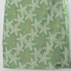 Sage green silk blend top and bottom coord set with cream floral print and gold-toned detailing.