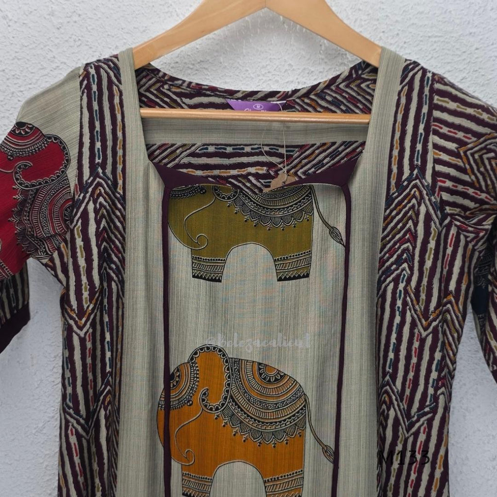Sand beige silk blend long kurta with multicolour elephant motifs, maroon chevron side panels and contrast half sleeves.