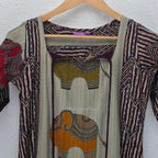 Sand beige silk blend long kurta with multicolour elephant motifs, maroon chevron side panels and contrast half sleeves.