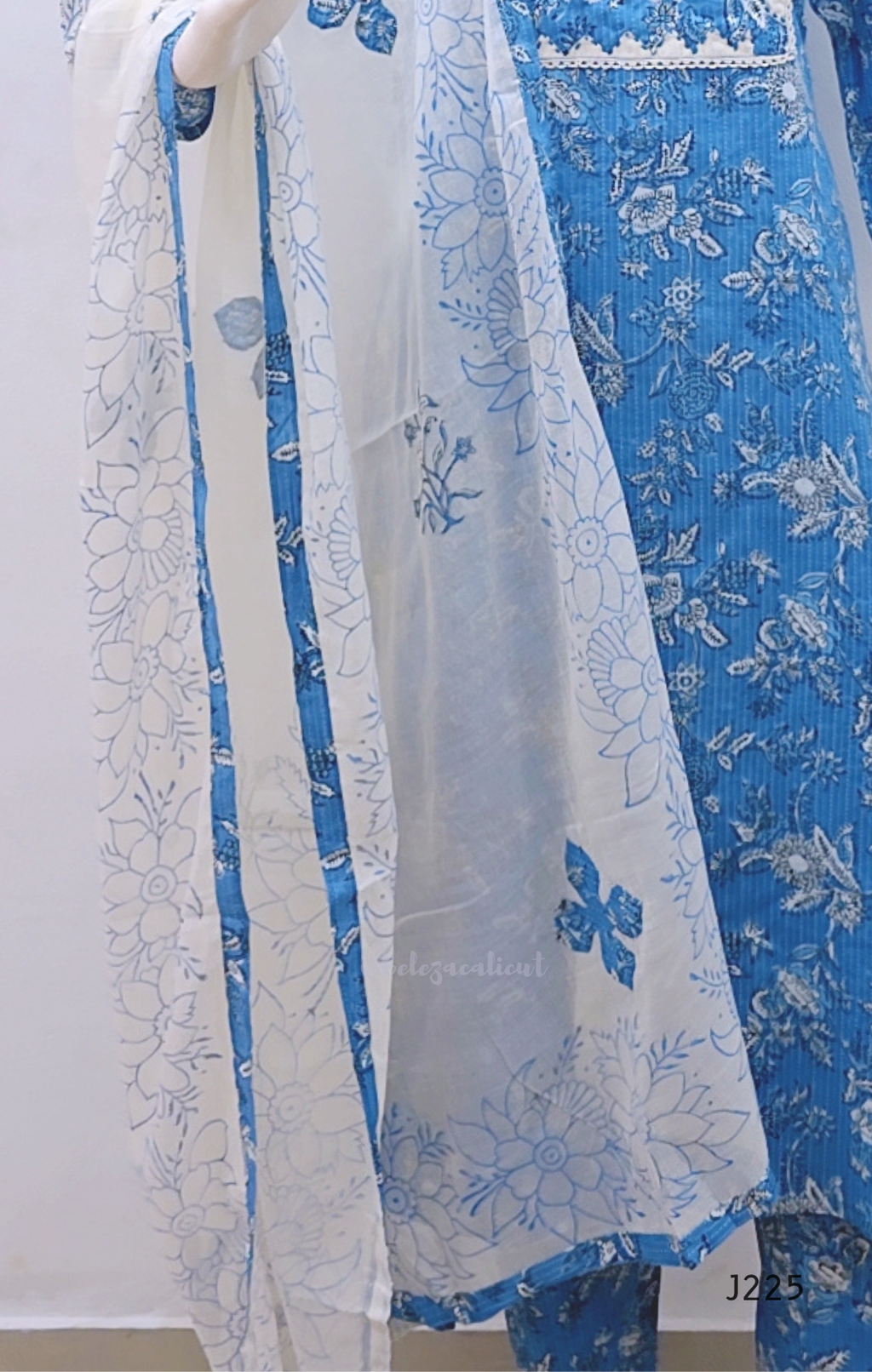 Sky blue premium kantha cotton churidar set with white floral print, applique yoke and cotton dupatta. Available at Beleza Calicut.