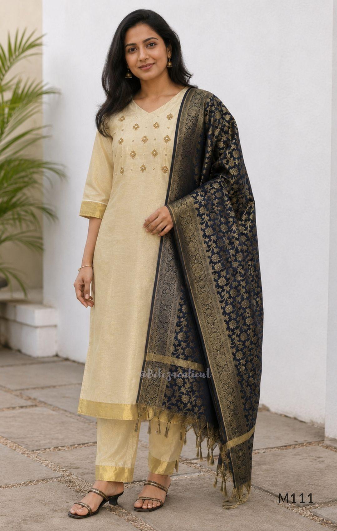 Soft gold tissue silk blend 3-piece set with gold front embroidery, matching bottom and deep navy antique gold zari dupatta.