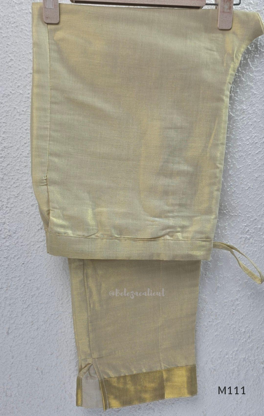 Soft gold tissue silk blend 3-piece set with gold front embroidery, matching bottom and deep navy antique gold zari dupatta.