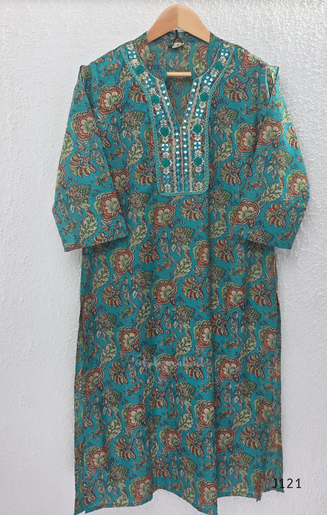 Teal blue Jaipur cotton churidar set with floral print, mirror-work neckline, matching printed bottom and dupatta.
