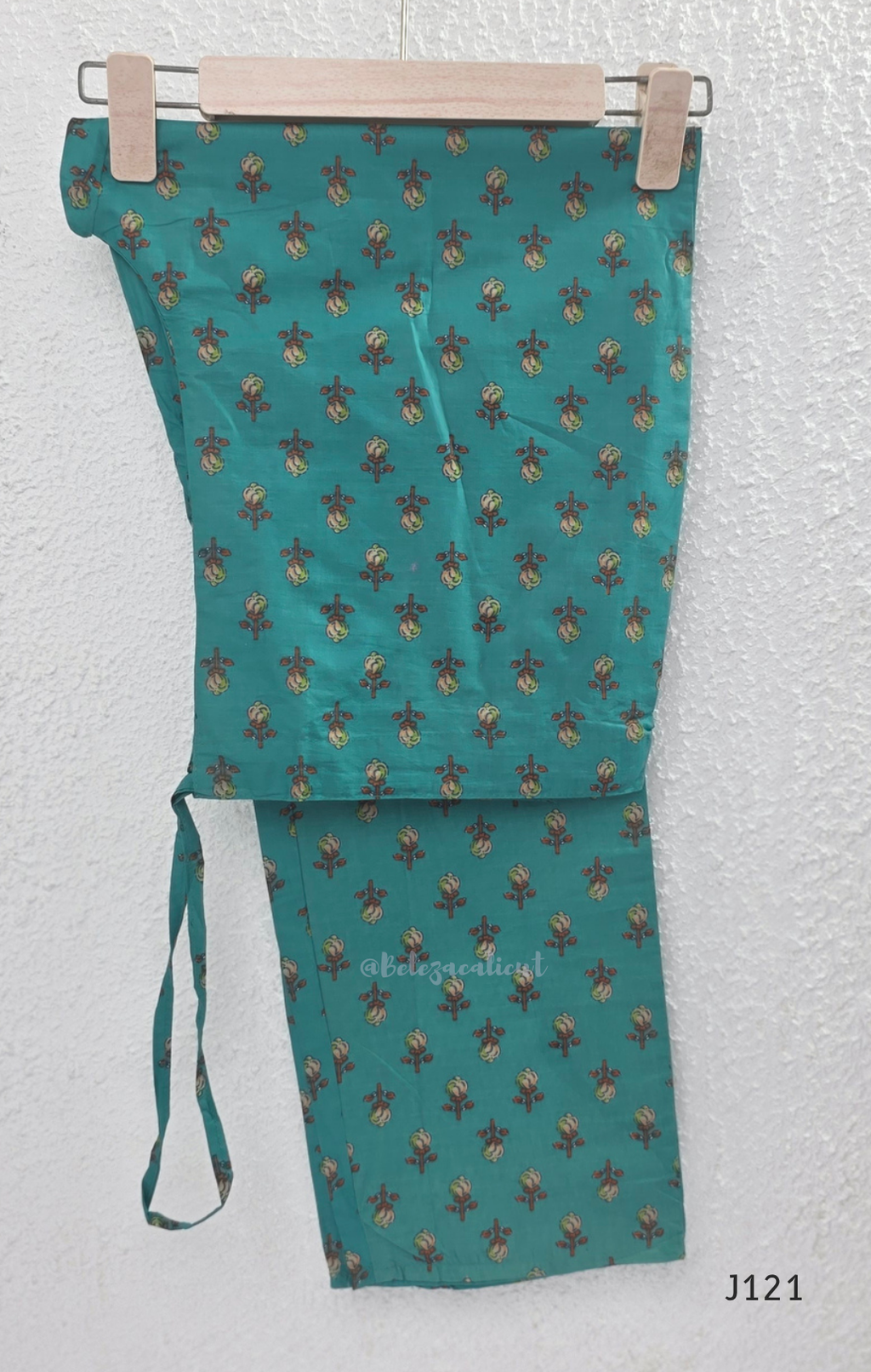 Teal blue Jaipur cotton churidar set with floral print, mirror-work neckline, matching printed bottom and dupatta.