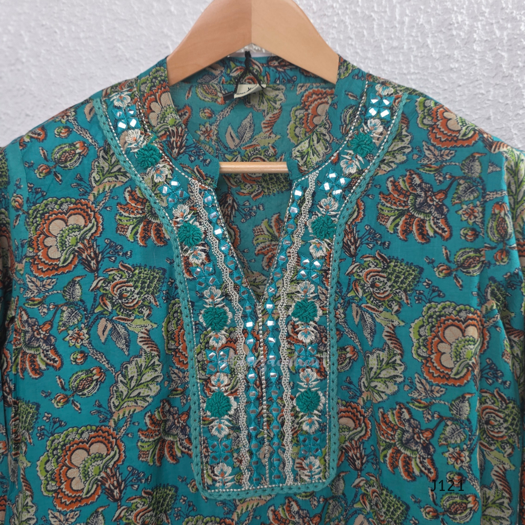 Teal blue Jaipur cotton churidar set with floral print, mirror-work neckline, matching printed bottom and dupatta.