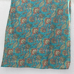 Teal blue Jaipur cotton churidar set with floral print, mirror-work neckline, matching printed bottom and dupatta.