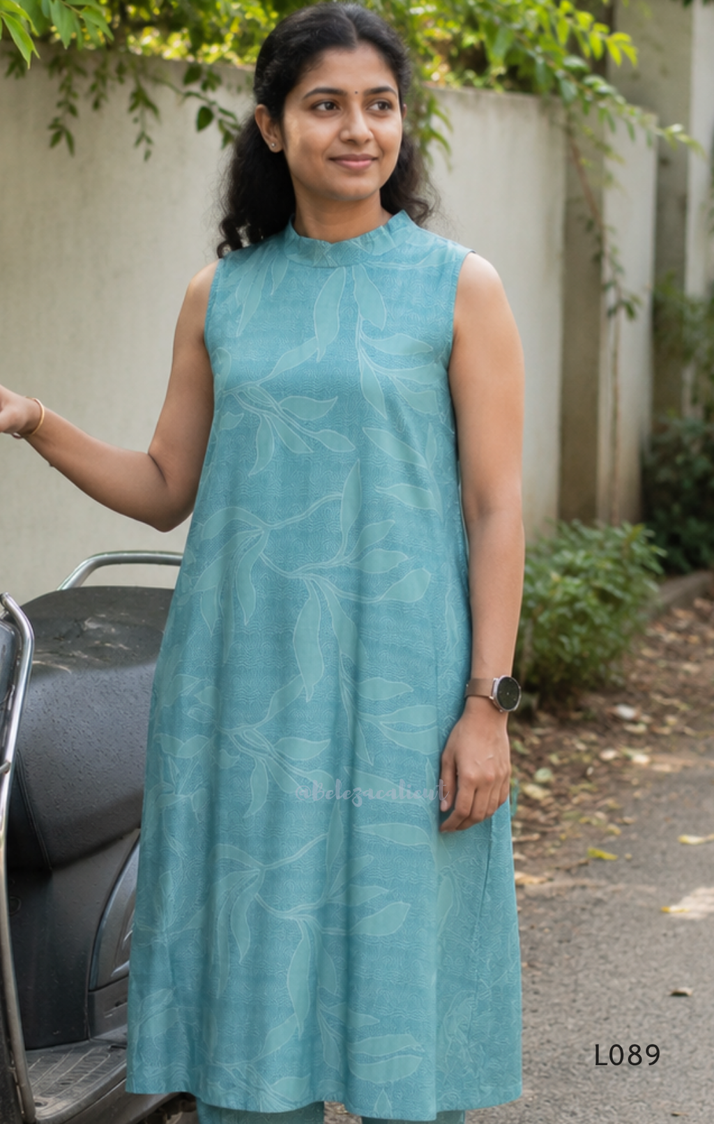 eal blue rayon blend 2-piece set with leaf line print, high neck top, back zip and matching printed straight pant.