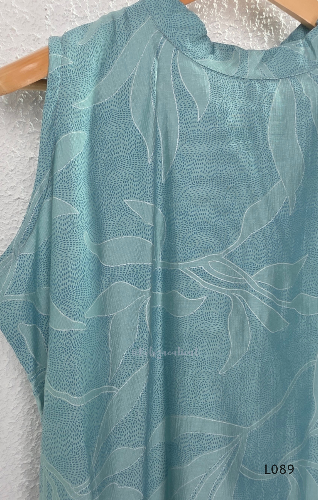 eal blue rayon blend 2-piece set with leaf line print, high neck top, back zip and matching printed straight pant.