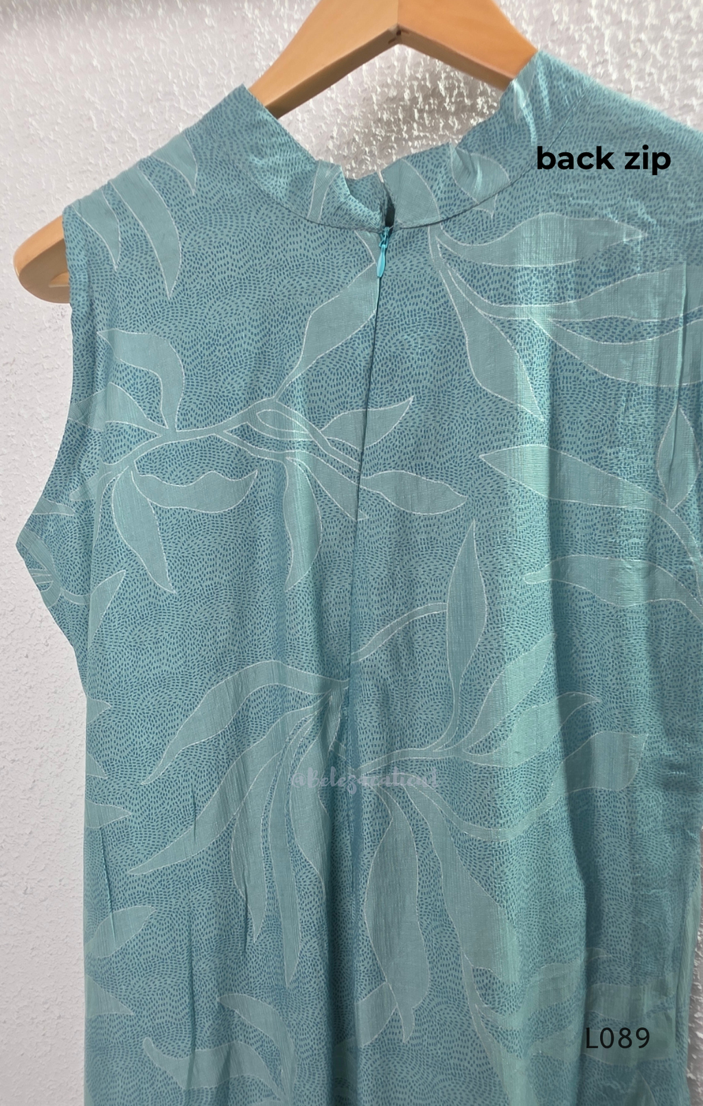eal blue rayon blend 2-piece set with leaf line print, high neck top, back zip and matching printed straight pant.