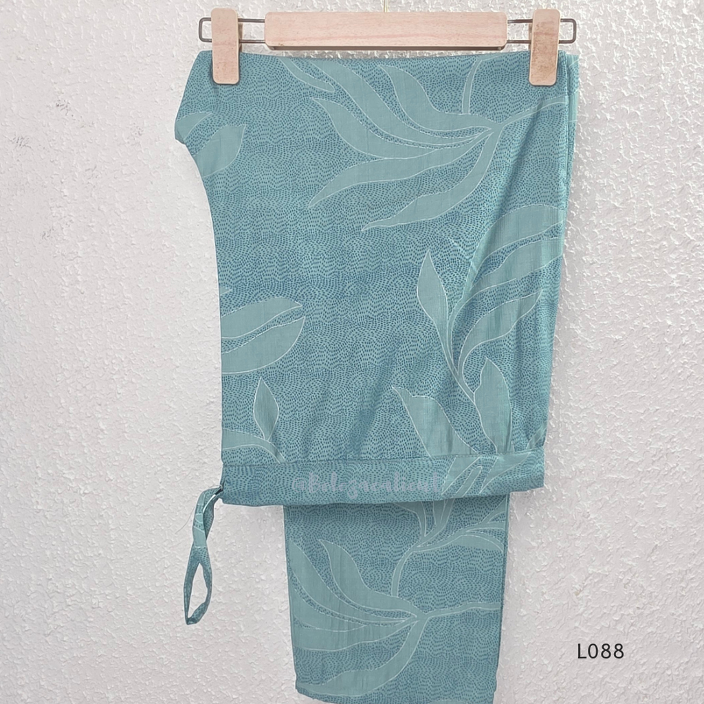 eal blue rayon blend 2-piece set with leaf line print, high neck top, back zip and matching printed straight pant.