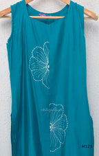 eal blue Vertigan silk coord set with white floral embroidery and straight pants.