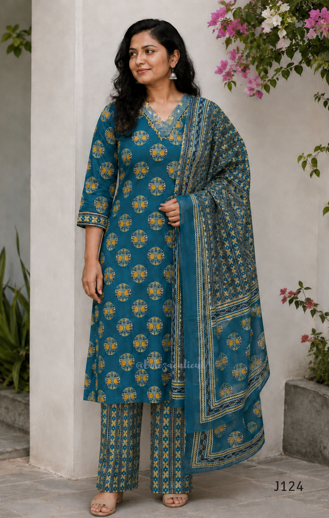 Teal green Jaipur cotton churidar set with V-neck detail, circular print, striped bottom and matching printed dupatta.