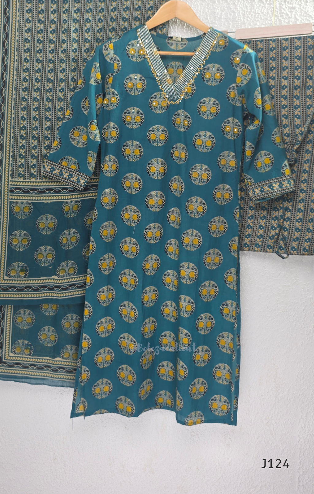 Teal green Jaipur cotton churidar set with V-neck detail, circular print, striped bottom and matching printed dupatta.