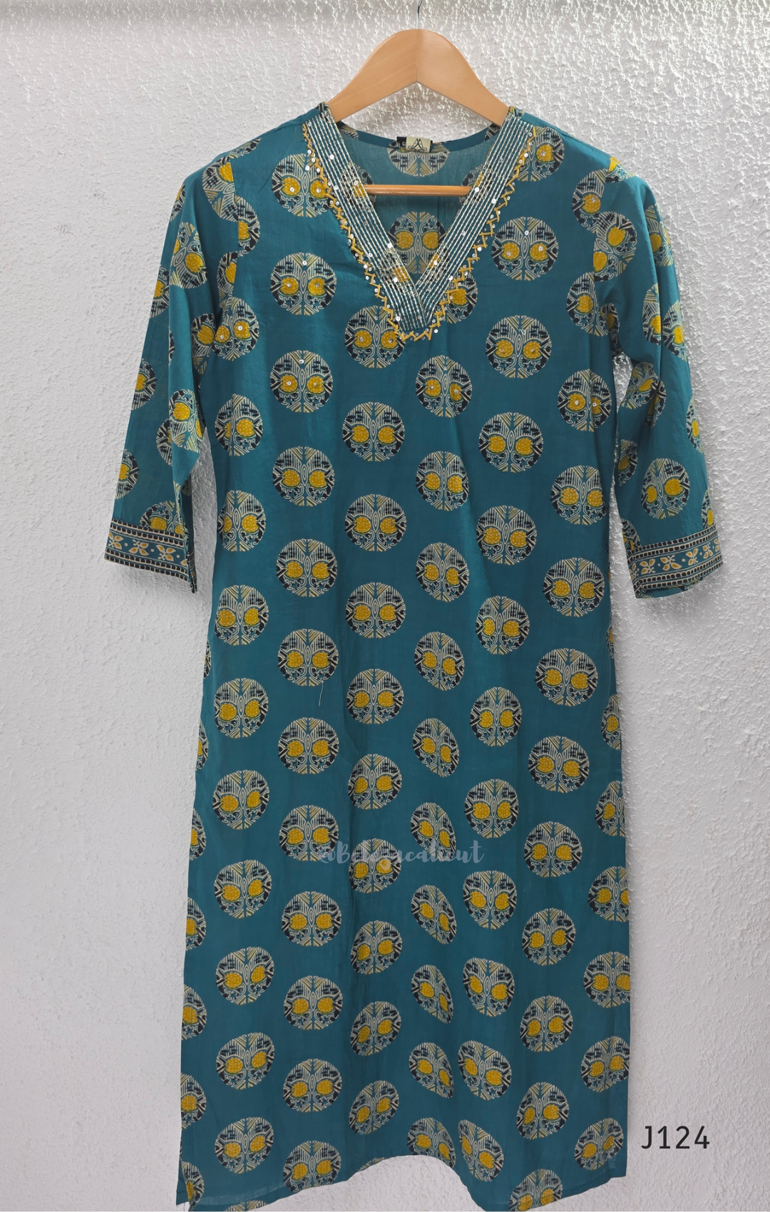 Teal green Jaipur cotton churidar set with V-neck detail, circular print, striped bottom and matching printed dupatta.