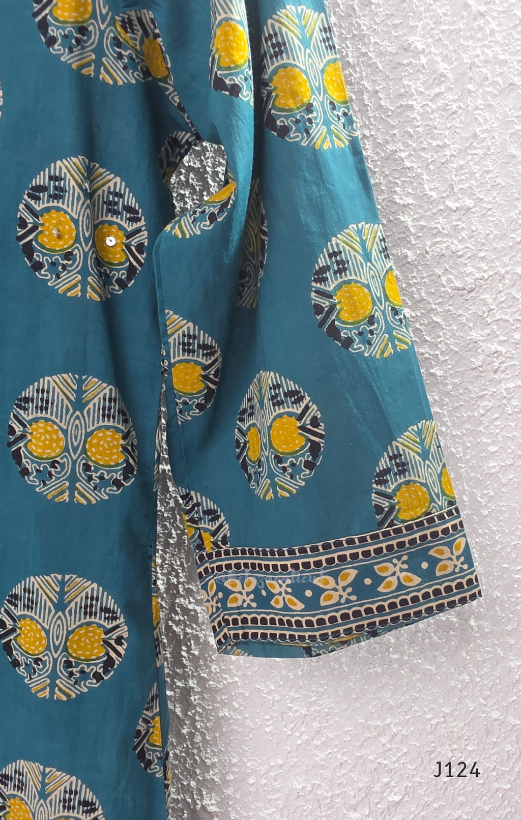 Teal green Jaipur cotton churidar set with V-neck detail, circular print, striped bottom and matching printed dupatta.