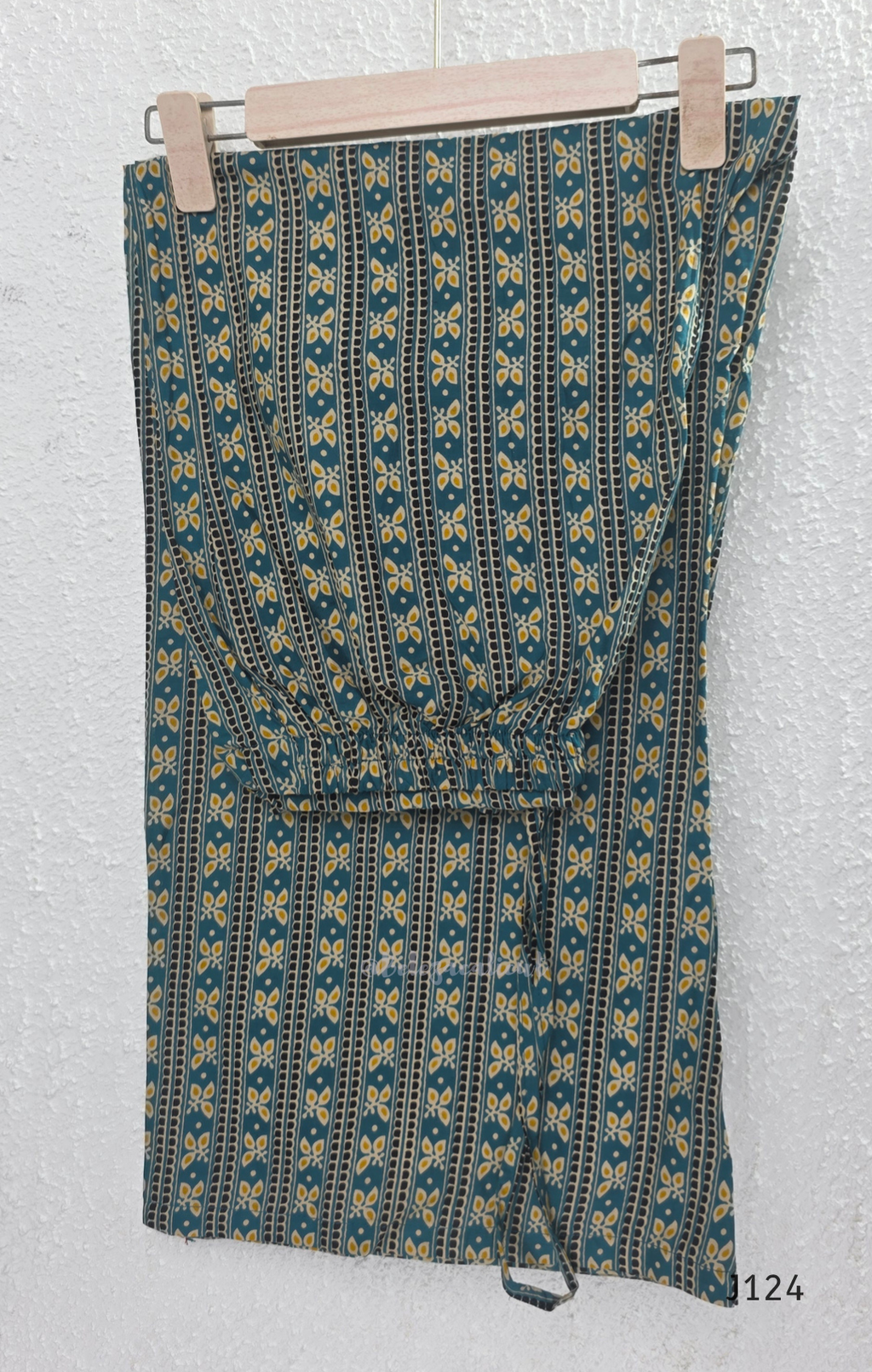 Teal green Jaipur cotton churidar set with V-neck detail, circular print, striped bottom and matching printed dupatta.