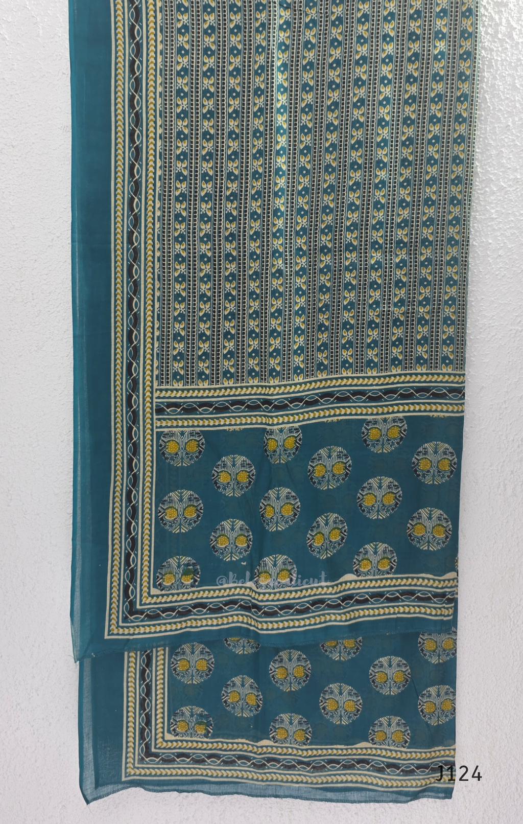 Teal green Jaipur cotton churidar set with V-neck detail, circular print, striped bottom and matching printed dupatta.