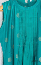 Teal Vertigan silk two-piece coord set with pleated A-line top, gold circular motifs and matching straight pants.