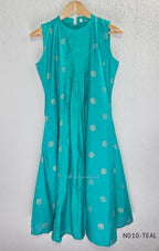Teal Vertigan silk two-piece coord set with pleated A-line top, gold circular motifs and matching straight pants.