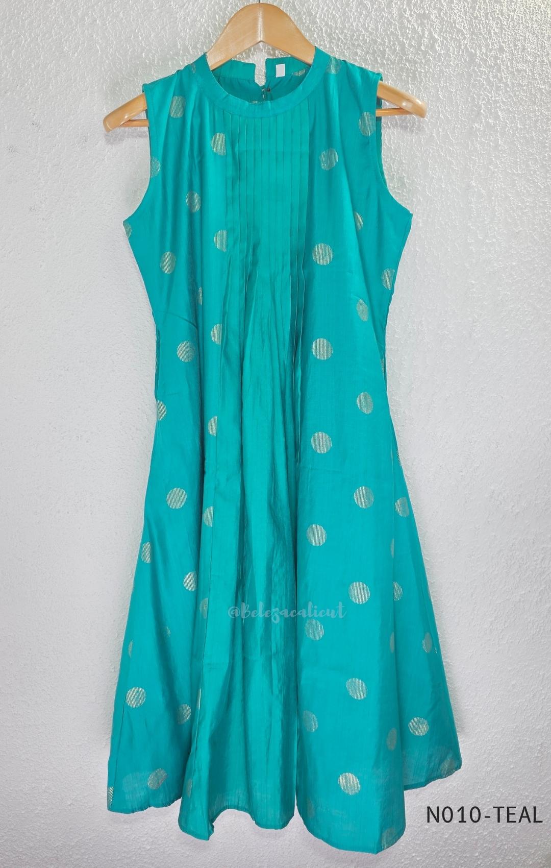 Teal Vertigan silk two-piece coord set with pleated A-line top, gold circular motifs and matching straight pants.