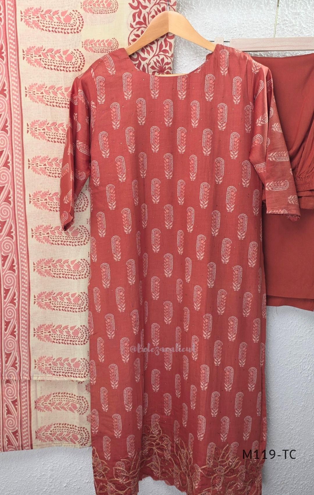 Terracotta Cotton Silk churidar set with paisley motifs, floral embroidered hem, matching straight pants and cream printed dupatta.