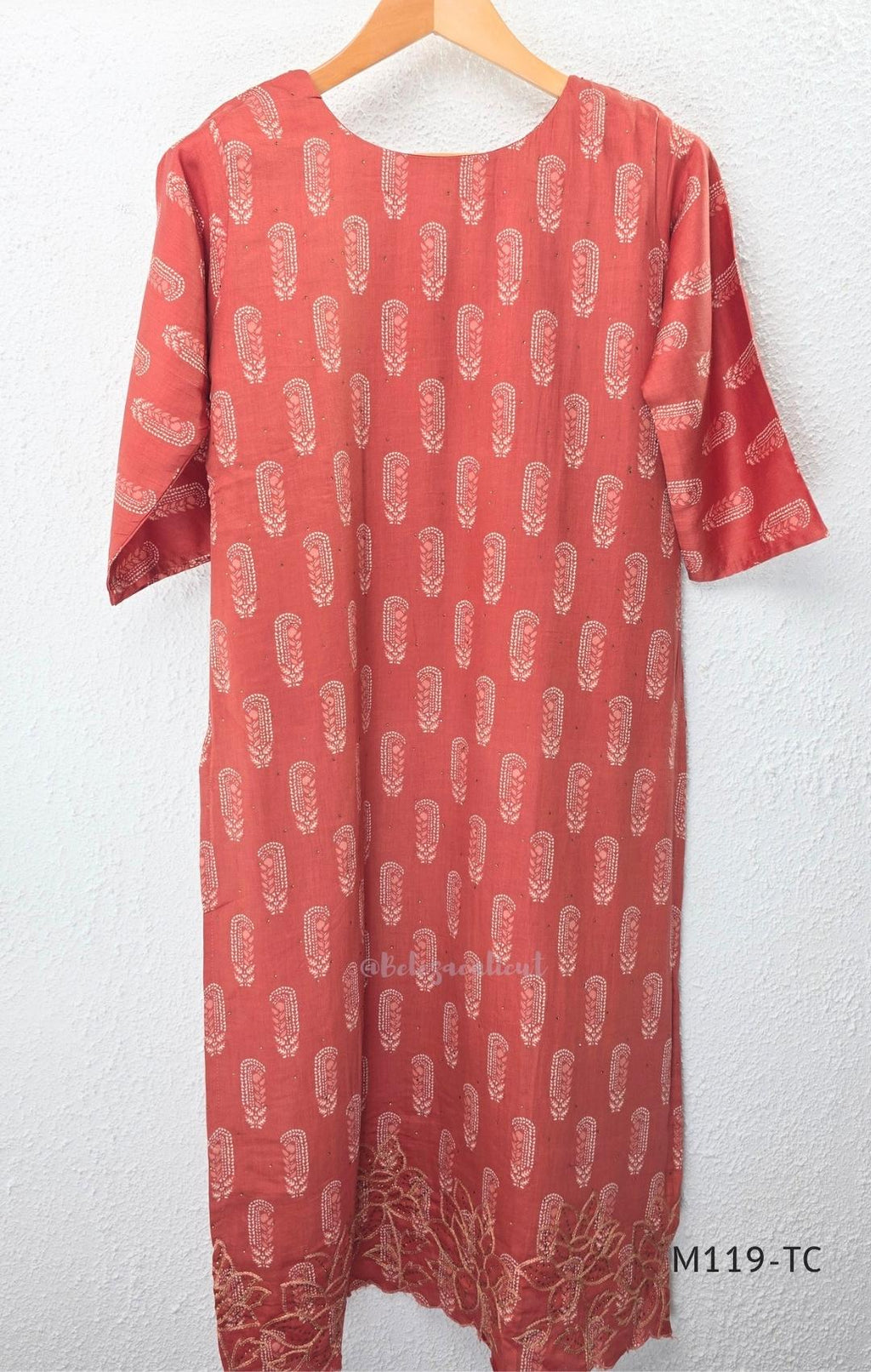 Terracotta Cotton Silk churidar set with paisley motifs, floral embroidered hem, matching straight pants and cream printed dupatta.