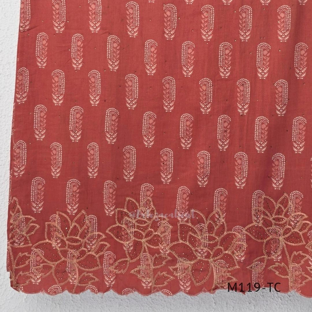 Terracotta Cotton Silk churidar set with paisley motifs, floral embroidered hem, matching straight pants and cream printed dupatta.