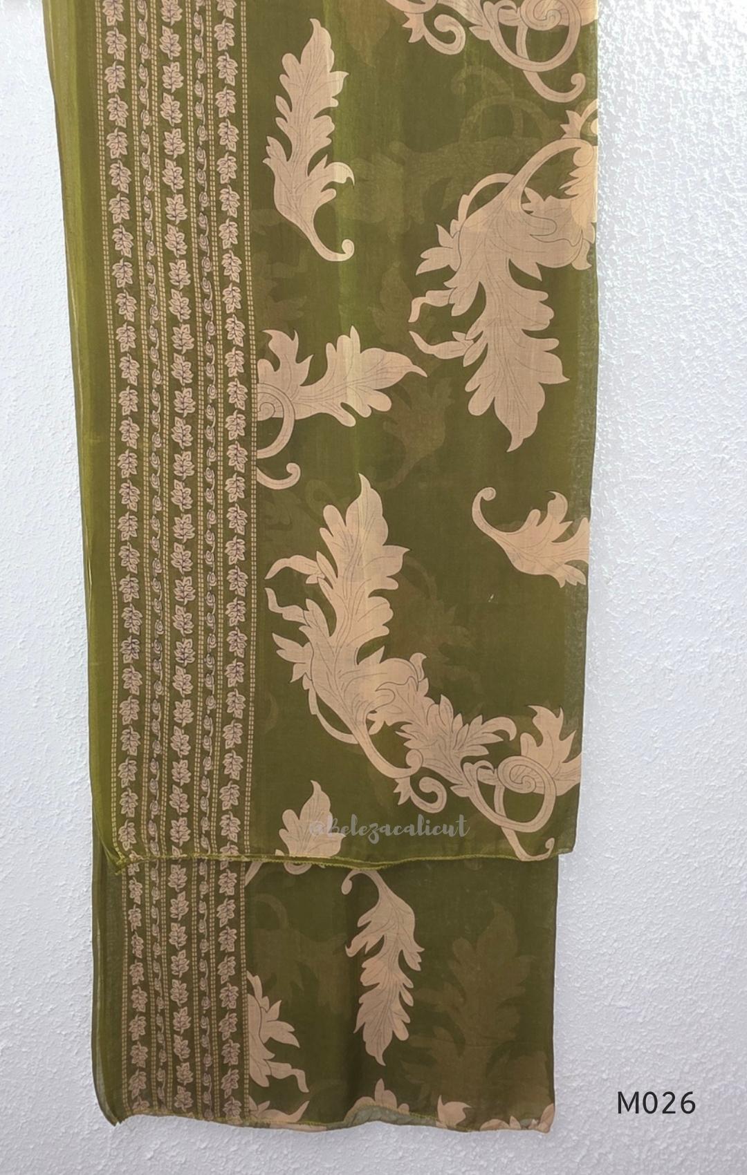 Olive green cotton 3-piece ethnic set with beige leaf print kurta, matching printed pant and dupatta.