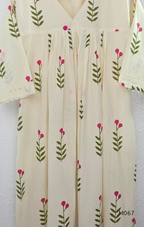 Warm ivory cotton lined 2-piece set with green stem and rose-pink blossom print, V-neckline, gathered front yoke and matching bottom.