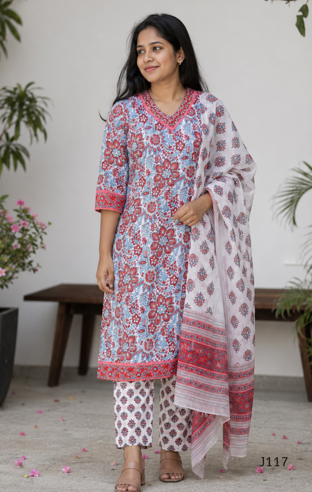 White ivory cotton 3-piece churidar set with dense red and blue kalamkari-style block print, gold sequin V-neckline, lace cuff, and printed dupatta with bold red border.