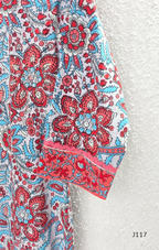 White ivory cotton 3-piece churidar set with dense red and blue kalamkari-style block print, gold sequin V-neckline, lace cuff, and printed dupatta with bold red border.
