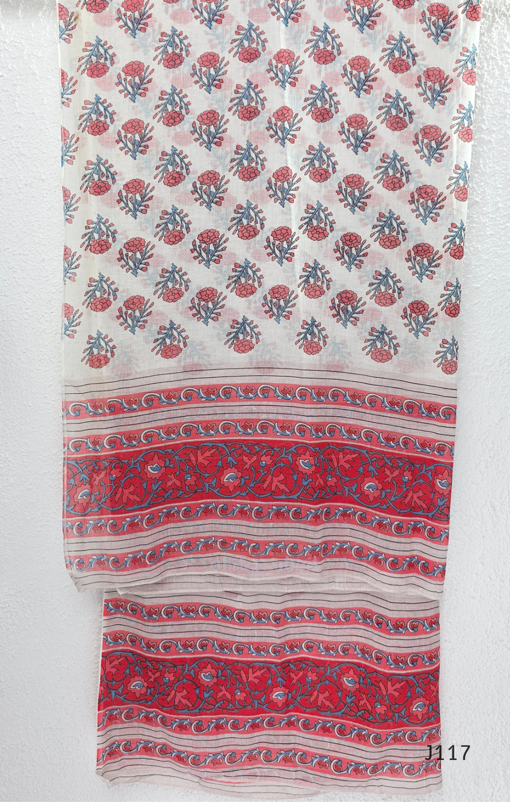 White ivory cotton 3-piece churidar set with dense red and blue kalamkari-style block print, gold sequin V-neckline, lace cuff, and printed dupatta with bold red border.