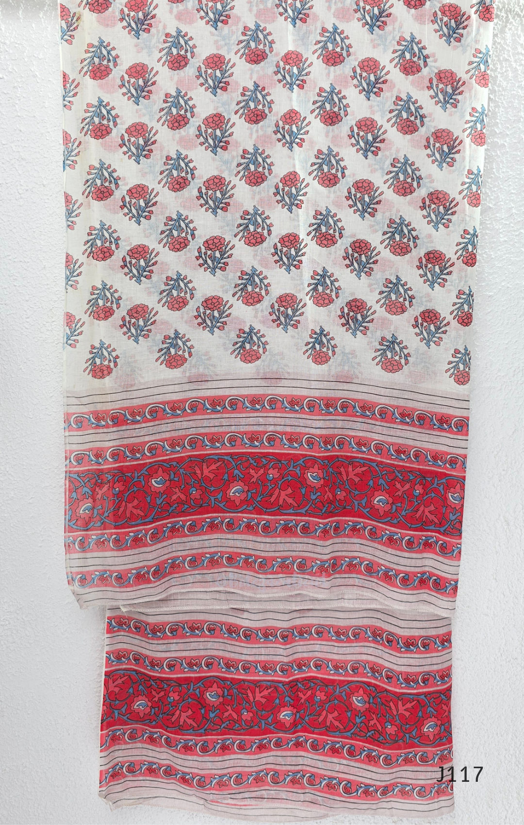 White ivory cotton 3-piece churidar set with dense red and blue kalamkari-style block print, gold sequin V-neckline, lace cuff, and printed dupatta with bold red border.