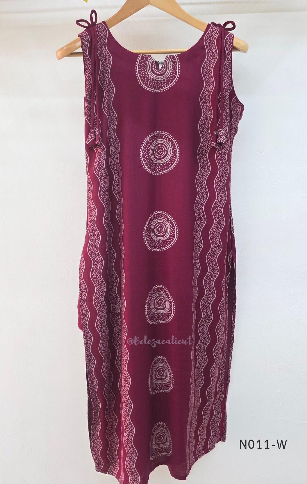 Wine Vertigan silk printed coord set with sleeveless shoulder-tie top and matching straight pants.